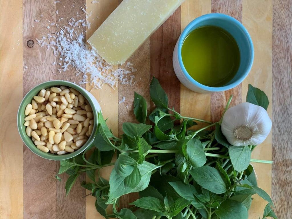 Italian Pesto Recipe ingredients on a cutting board
