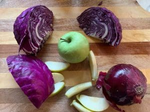 Sweet and sour red cabbage ingredients on a cutting board