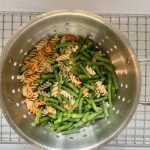 Rotini and green beans in the colander