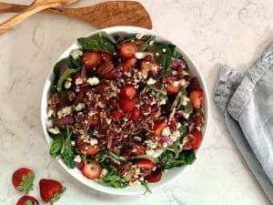 Strawberry Arugula Salad in a white serving bowl