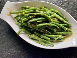 Honey Ginger Green Beans in a white serving dish
