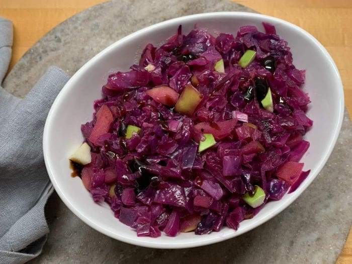 Sweet and sour red cabbage with apples in a serving bowl