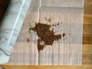 crush cumin seeds between wax paper