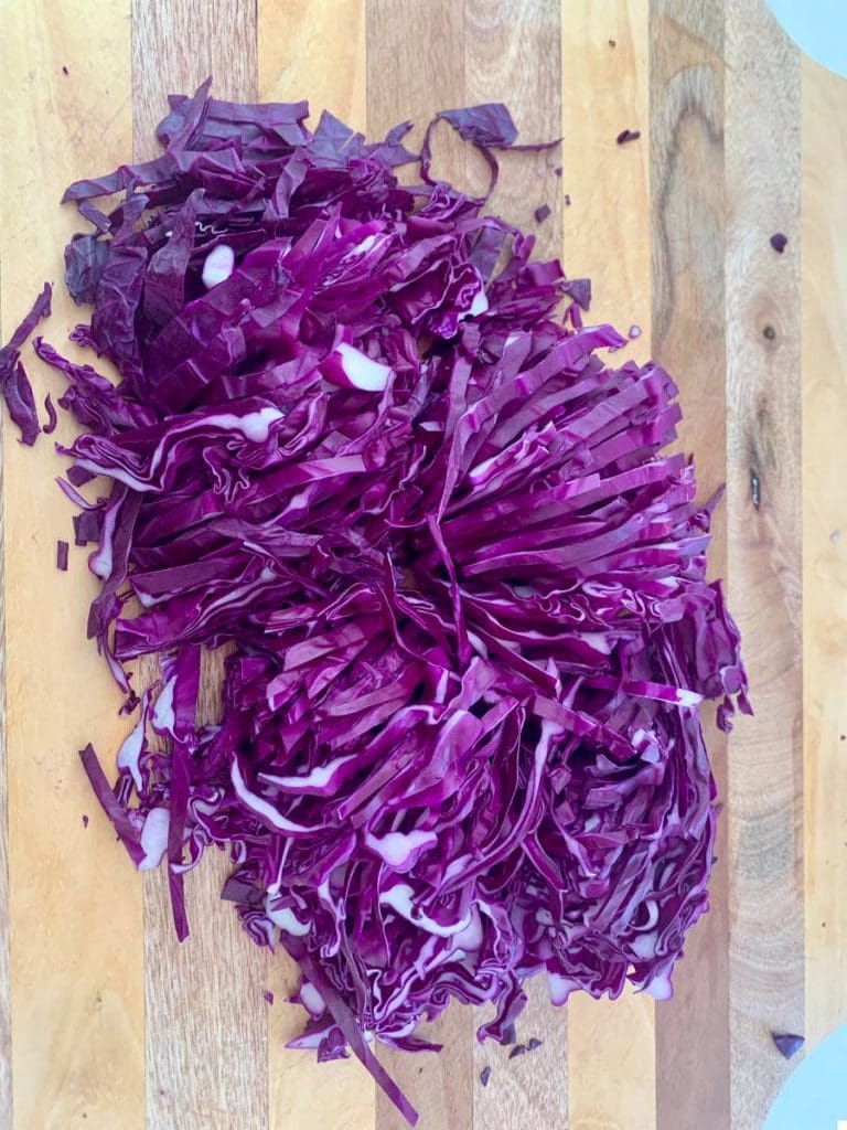 Cut red cabbage on a cutting board.