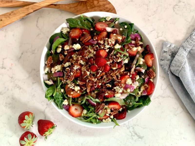 Strawberry Arugula Salad in a white serving bowl