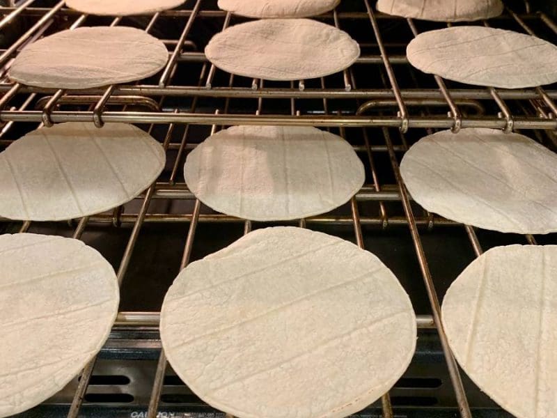 corn tortillas toasting directly on the rack in the oven